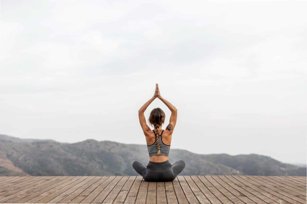 Back View Woman Doing Yoga Outdoors (1)