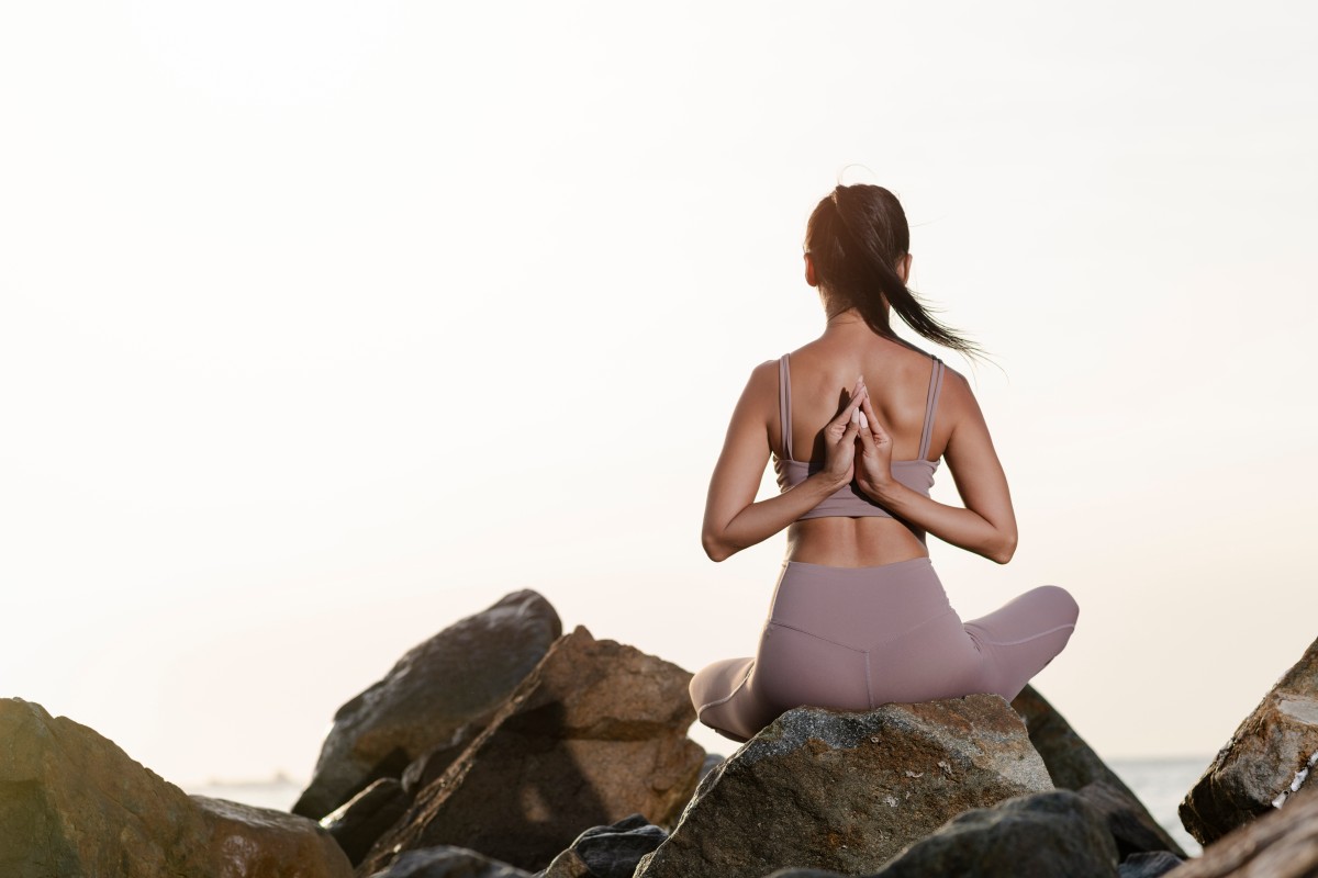 Full Shot Woman Meditating Rocks (1)